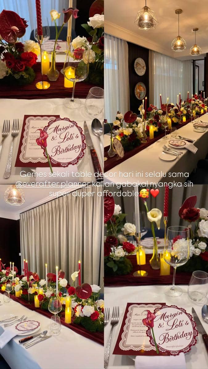 Dekorasi meja ulang tahun dengan tema elegan merah marun dan putih, dihiasi bunga segar, lilin, serta peralatan makan tertata rapi.