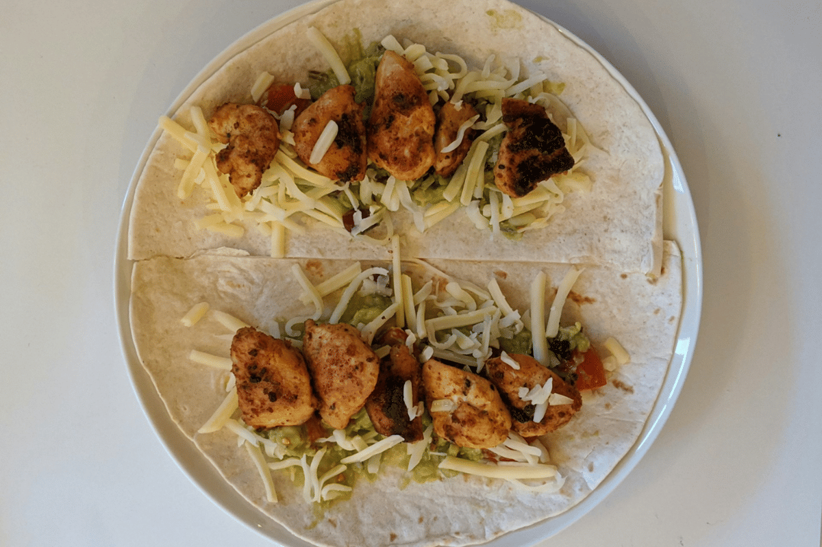 Ilustrasi proses membuat chicken snack wrap dengan isian ayam, disiapkan sebagai camilan praktis dan mudah dinikmati.