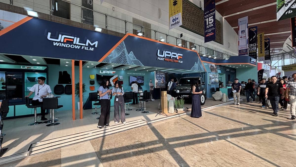 Booth UPPF dan UFILM dalam sebuah acara, dengan area pameran yang menampilkan identitas kedua merek.