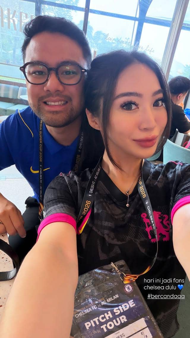 Seorang perempuan berambut panjang tersenyum di tribun Stadion GBK saat menyaksikan pertandingan Chelsea.