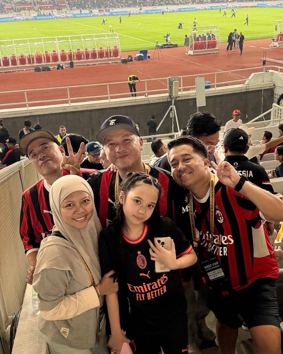 Gempi berdiri di lapangan Stadion GBK sebagai pendamping pemain AC Milan sebelum pertandingan dimulai.