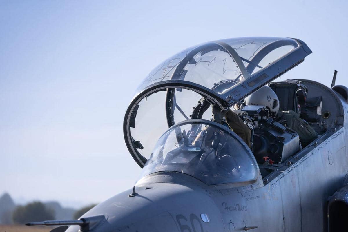Dua pilot militer sedang berada di dalam pesawat jet tempur.