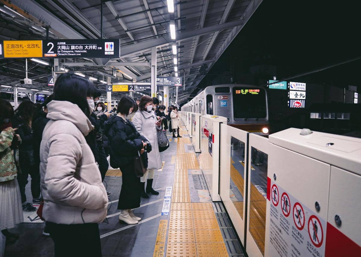 para penumpang menunggu kereta api di stasiun