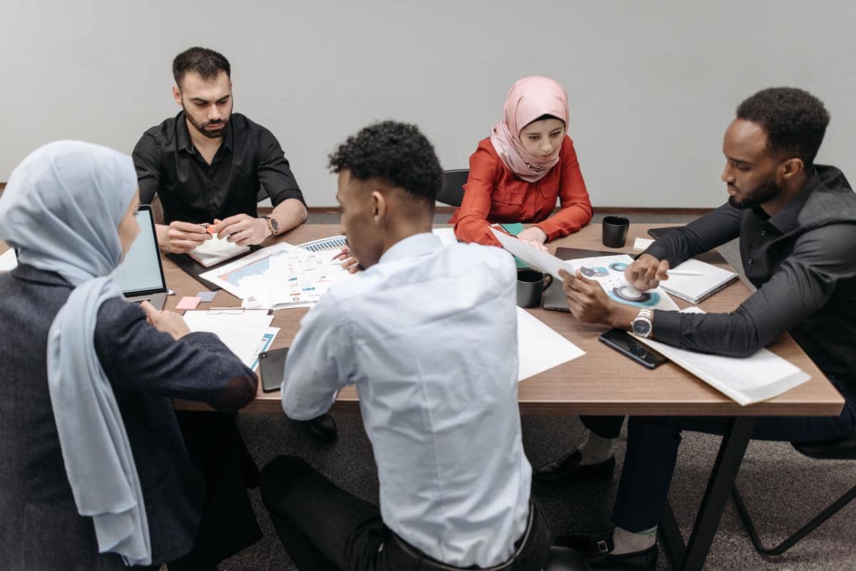 Enam orang dari latar belakang berbeda sedang berdiskusi 