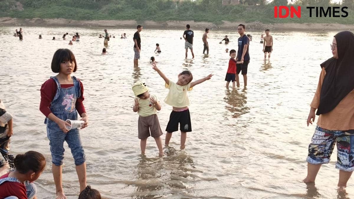 Warga Sekayu saat bermain di Pantai Bongen, atau Sungai Musi yang surut akibat kemarau.