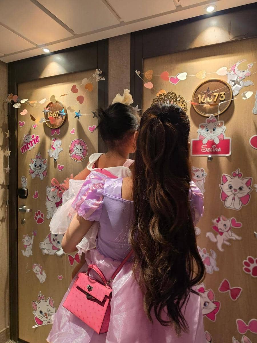 Mahalini dan Rizky Febian berpose bersama di area Disney Cruise saat menikmati liburan dengan latar kapal pesiar.