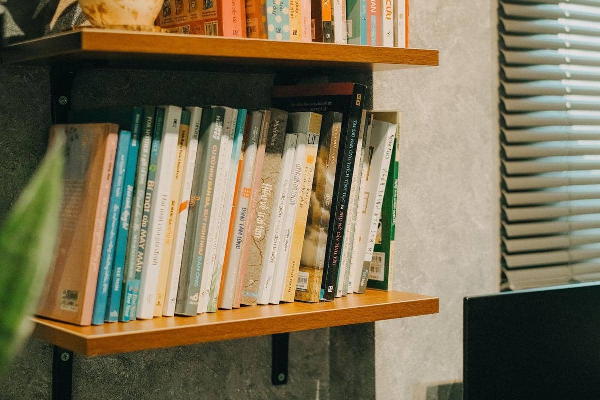 menyusun buku di rak dengan rapi