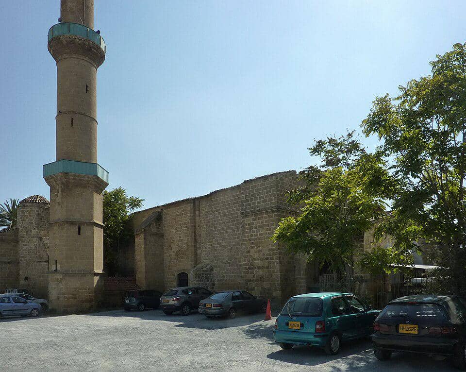Pemandangan area parkir di samping Masjid Omeriye, dengan ruang terbuka serta bangunan di sekitar kompleks masjid.