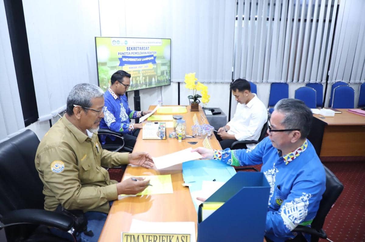 Prof. Dr. Hamzah menyerahkan berkas pendaftaran calon Rektor Unila 2027 kepada panitia pendaftaran.