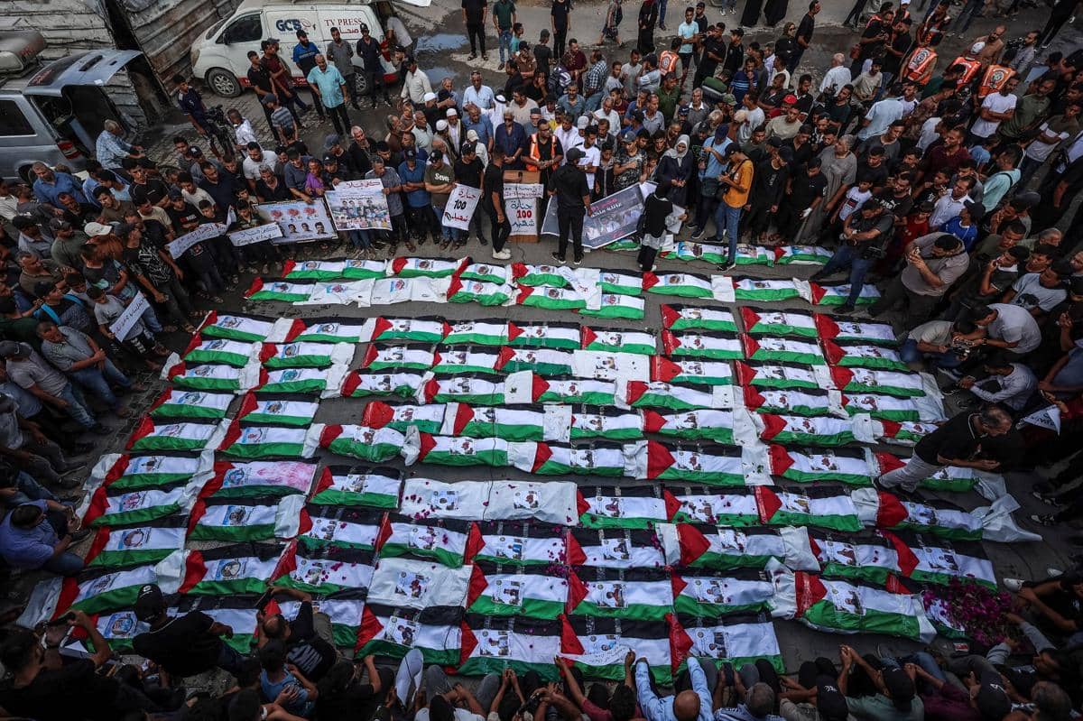 Para pelayat berkumpul untuk pemakaman massal sekitar 100 warga Palestina—termasuk 62 anak-anak—yang jenazahnya dievakuasi dari reruntuhan.