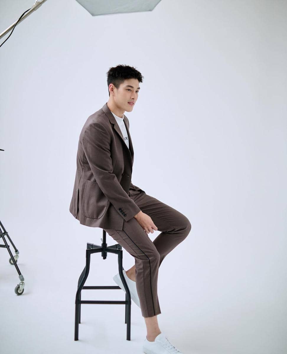 Krating Khunnarong mengenakan setelan jas untuk inspirasi OOTD pria bergaya rapi dan modern dalam potret Instagram.