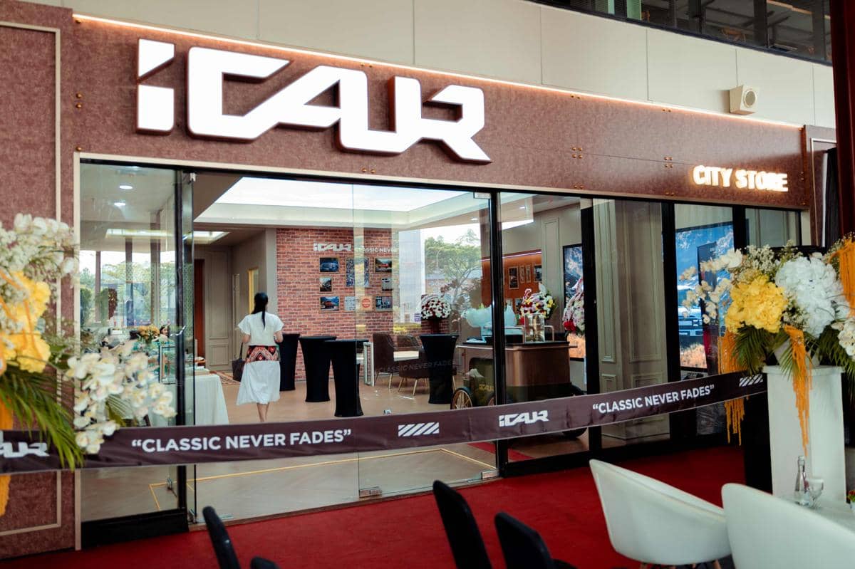 Tampak depan outlet baru iCAR di BSD dengan fasad bangunan modern serta area parkir kendaraan di depannya.