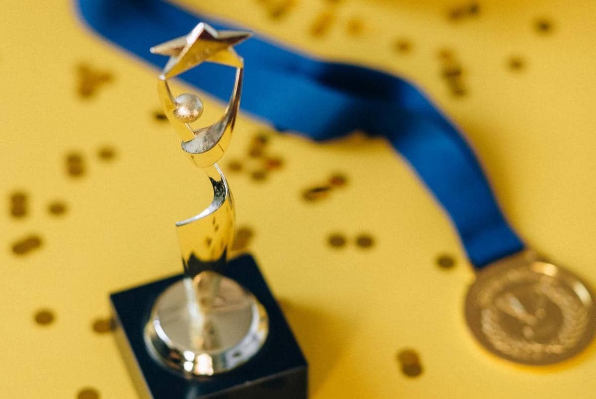 Penghargaan berupa piala.