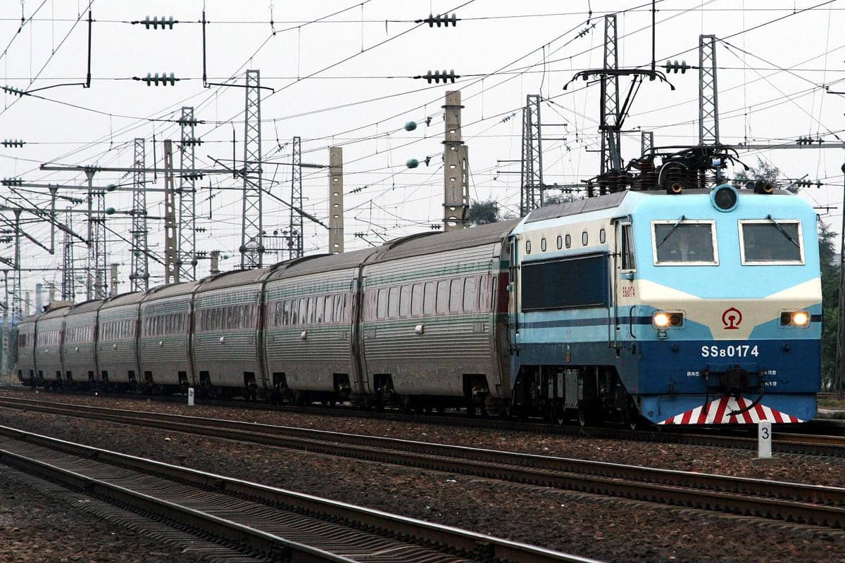 Kereta penumpang melaju di jalur rel di China, memperlihatkan suasana perjalanan dan transportasi kereta api.
