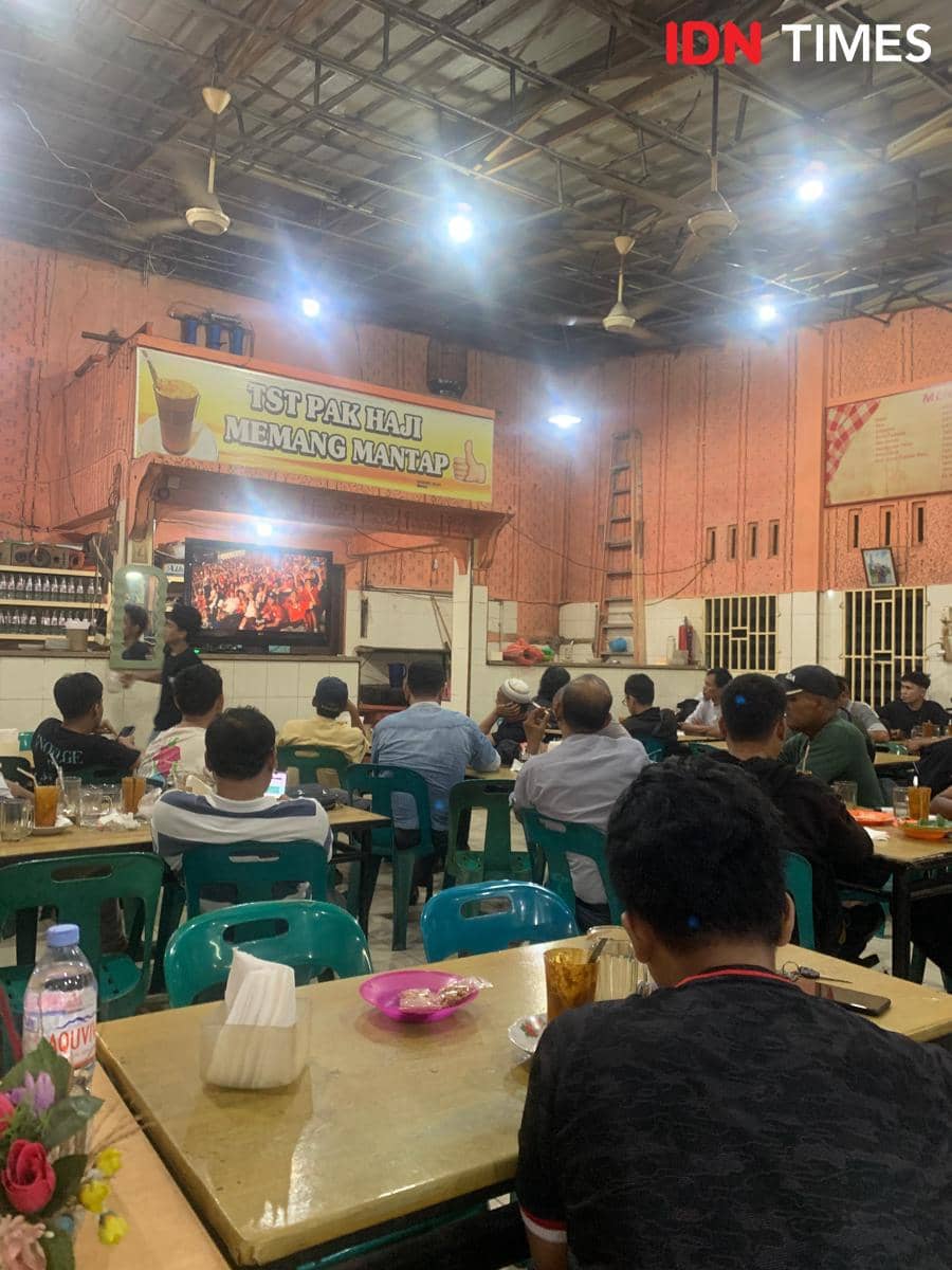 Sejumlah pengunjung menyaksikan pertandingan Timnas Indonesia bersama-sama dalam acara nobar di Warung TST Pak Haji, Kota Medan.