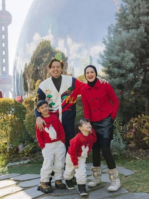 Cut Meyriska bersama keluarga mengenakan busana kasual bernuansa serasi untuk perjalanan, sebagai inspirasi OOTD traveling.